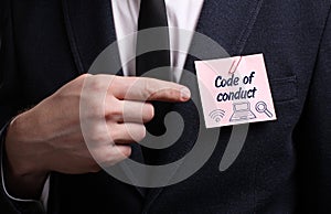 Business, Technology, Internet and network concept. Young businessman shows the word: Code of conduct