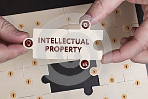 Business, Technology, Internet and network concept. Young businessman shows the word: Intellectual property
