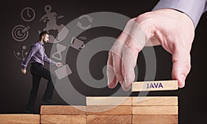 Business, Technology, Internet and network concept. Young businessman shows the word: Java