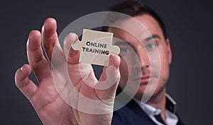 Business, Technology, Internet and network concept. Young businessman shows the word: Online training