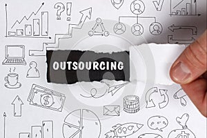 Business, Technology, Internet and network concept. Young businessman shows the word: Outsourcing