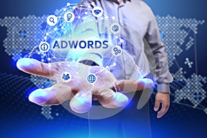 Business, Technology, Internet and network concept. Young businessman shows the word on the virtual display of the future: AdWords