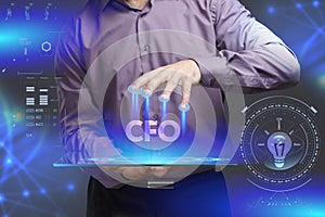 Business, Technology, Internet and network concept. Young businessman shows the word on the virtual display of the future: CFO