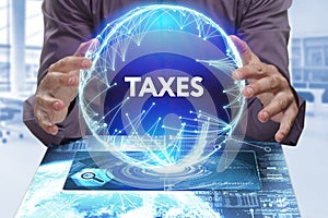 Business, Technology, Internet and network concept. Young businessman shows the word on the virtual display of the future: Taxes