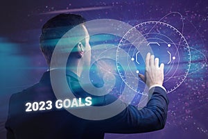 Business, technology, internet and network concept. Young businessman thinks over the steps for successful growth: 2023 goals