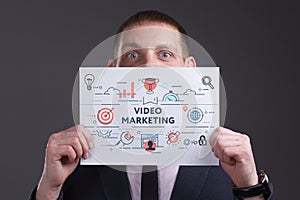 Business, technology, internet and network concept. Young businessman thinks over the steps for successful growth: Video marketing