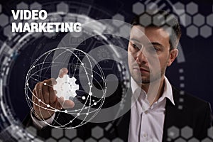 Business, technology, internet and network concept. Young businessman thinks over the steps for successful growth: Video marketing