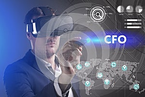 Business, Technology, Internet and network concept. Young businessman working in virtual reality glasses sees the inscription: CFO