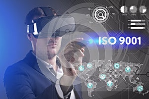 Business, Technology, Internet and network concept. Young businessman working in virtual reality glasses sees the inscription: ISO