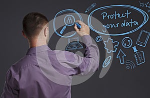 Business, Technology, Internet and network concept. A young businessman writes on the blackboard the word: Protect your data photo