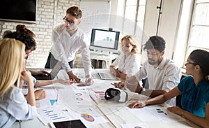 Business, technology and people concept - creative team or designers working in office