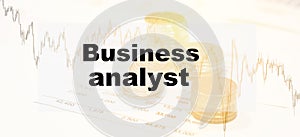 Business text - Business analytics, on a financial background with papers and coins