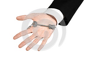 Business theme: real estate agent in the jacket in his hand the key to a new apartment on the white isolated background