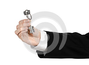 Business theme: real estate agent in the jacket in his hand the key to a new apartment on the white isolated background