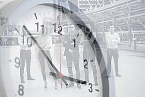 Business time clock face overlay with group of successful business people standing outdoor