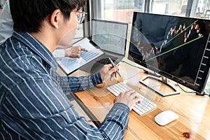 Business trader team checking stock market online analyzing graph data on laptop screen to brainstorming about trading online