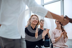 Business training participants applaud at the seminar