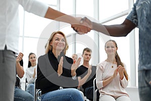 Business training participants applaud at the seminar