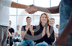 Business training participants applaud at the seminar