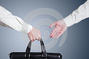 Business transfer deal. handover of a suitcase