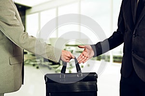 Business transfer. handover of a suitcase partners