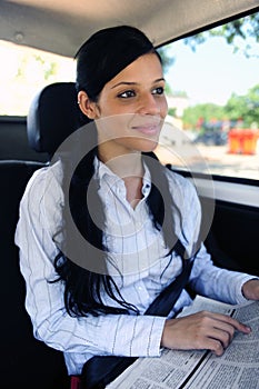 Business travel: businesswoman reading newspaper