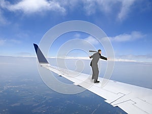 Business Travel Concept, Businessman Flying on Jet Plane Wing, Trip photo