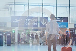 Business travel, man passenger in airport waiting for the flight