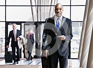 Business traveler holding briefcase, passport