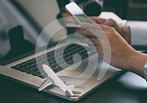 Business traveler using phone to book his trip