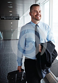 This business trip is going great so far. an executive businessman walking through an airport during a business trip.