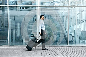 Business Trip. Man Traveling With Case At Airport