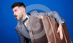 Business trip with retro suitcase. heavy bag. mature traveller. stylish esthete with vintage bag. bearded man in formal