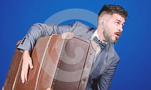 Business trip with retro suitcase. heavy bag. mature traveller. stylish esthete with vintage bag. bearded man in formal