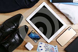 Business trip stuff on wooden surface, flat lay