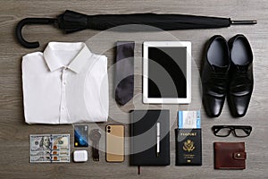 Business trip stuff on wooden surface, flat lay