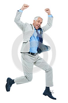 Business victory. Full length studio shot of a mature businessman jumping for joy isolated on white.