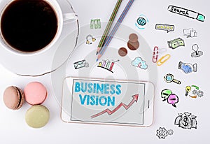 Business Vision Concept. Mobile phone and coffee cup on a white office desk