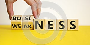 Business or weakness symbol. Businessman changes the word 'weakness' to 'business'.