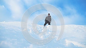 Business win success concept. Man traveler standing on top of a mountain hiking in winter mountains silhouette sunlight