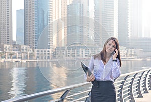 Business woman accepting a phone call.