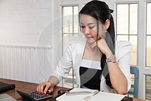 Business woman accountant or banker using calculator in retro office. Savings, finances and economy concept