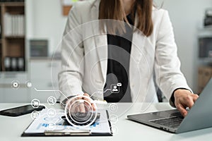 Business woman or accountant working on laptop computer with business document, graph diagram and calculator on office table in