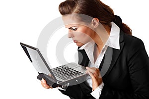 Business woman amazedly looks in laptops screen