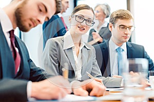 Business woman amidst team working in office