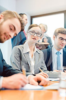 Business woman amidst team working in office