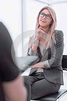 business woman answering questions during an interview.
