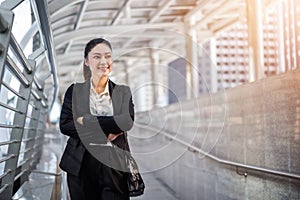 Business woman with arms crossed in city