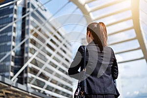 Business woman with arms crossed in city