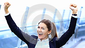 business woman with arms up celebrating outdoor